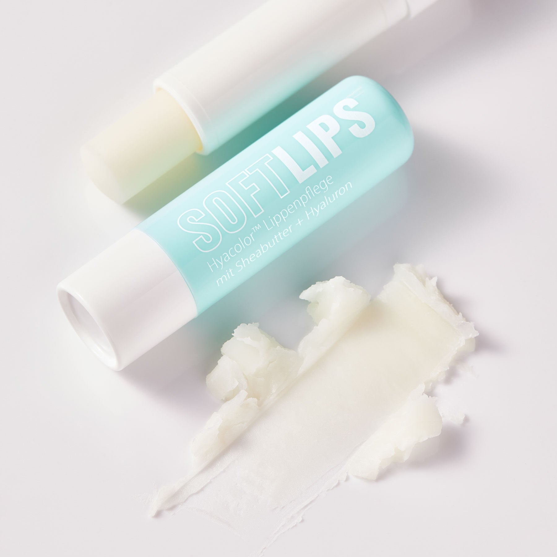 Dr. Massing SoftLips Lippenpflege mit Hyaluron Lippenpflege mit Sheabutter Detailansicht Textur auf weißen Hintergrund petrolfarbige Verpackung